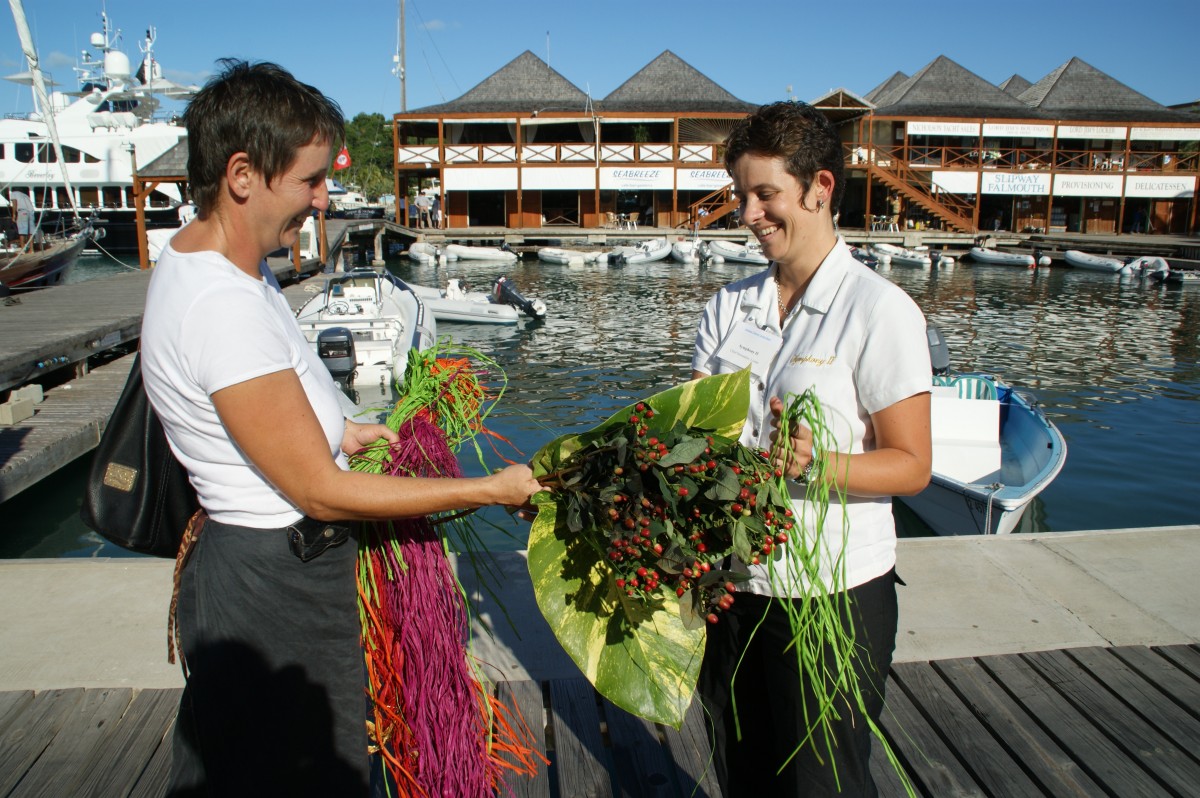 A chief yacht stewardess pays for a floral display delivery.